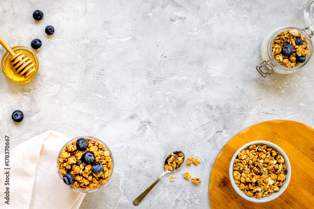 Oat flakes and berries granola glass on table background top vie