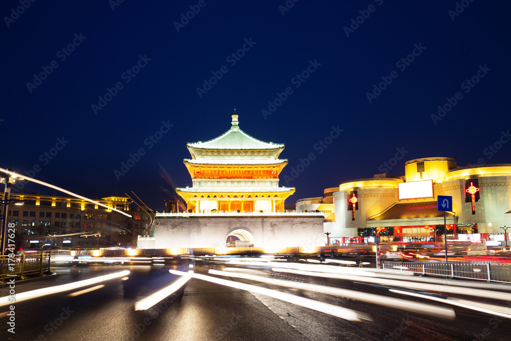 busy road and old style architecture at night