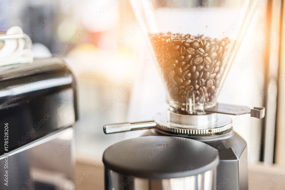 coffee making with coffee bean in blender machine in cafe with color tone concept