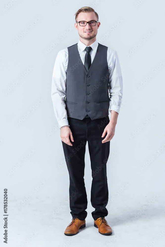 Young handsome man with great smile wearing fashion eyeglasses against neutral background