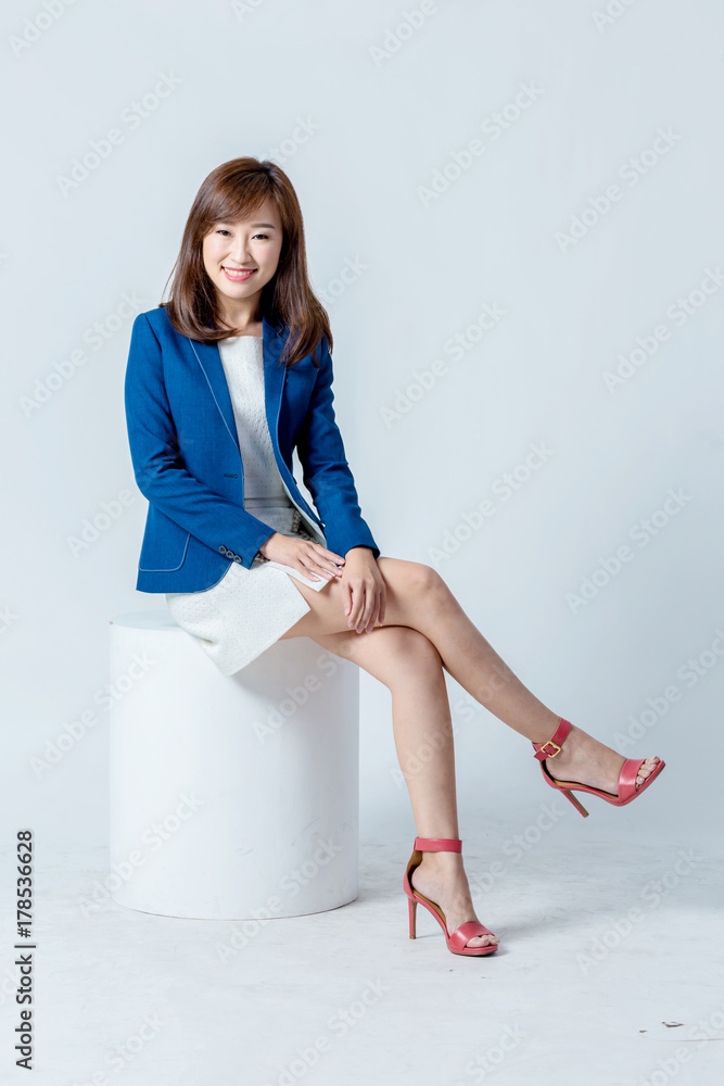 asian woman in blue suit happiness action pose in studio isolate white background