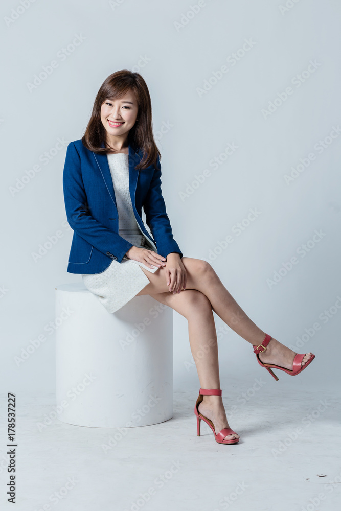 asian woman in blue suit happiness action pose in studio isolate white background