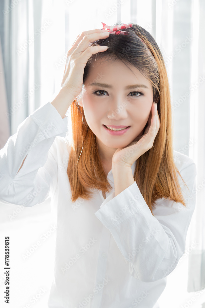 beautiful asian girl pose for beauty concept with white shirt and white room background