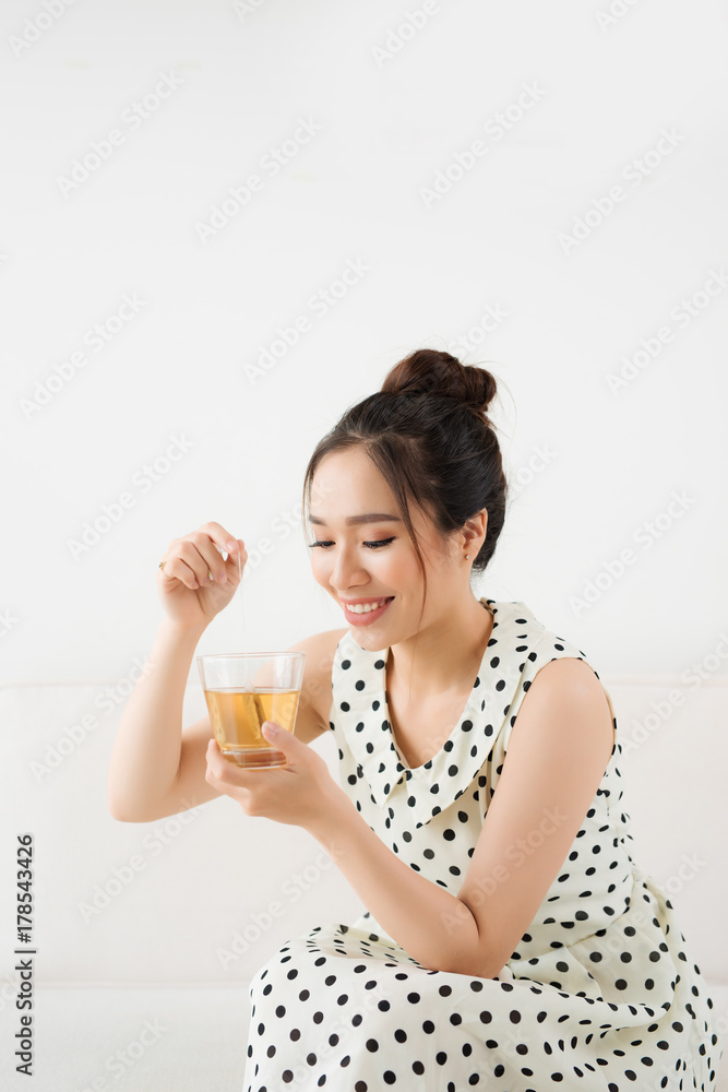 年轻迷人的亚洲女人喝热茶