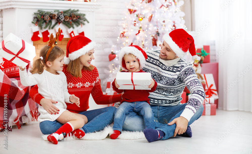 happy family mother father and children on Christmas morning