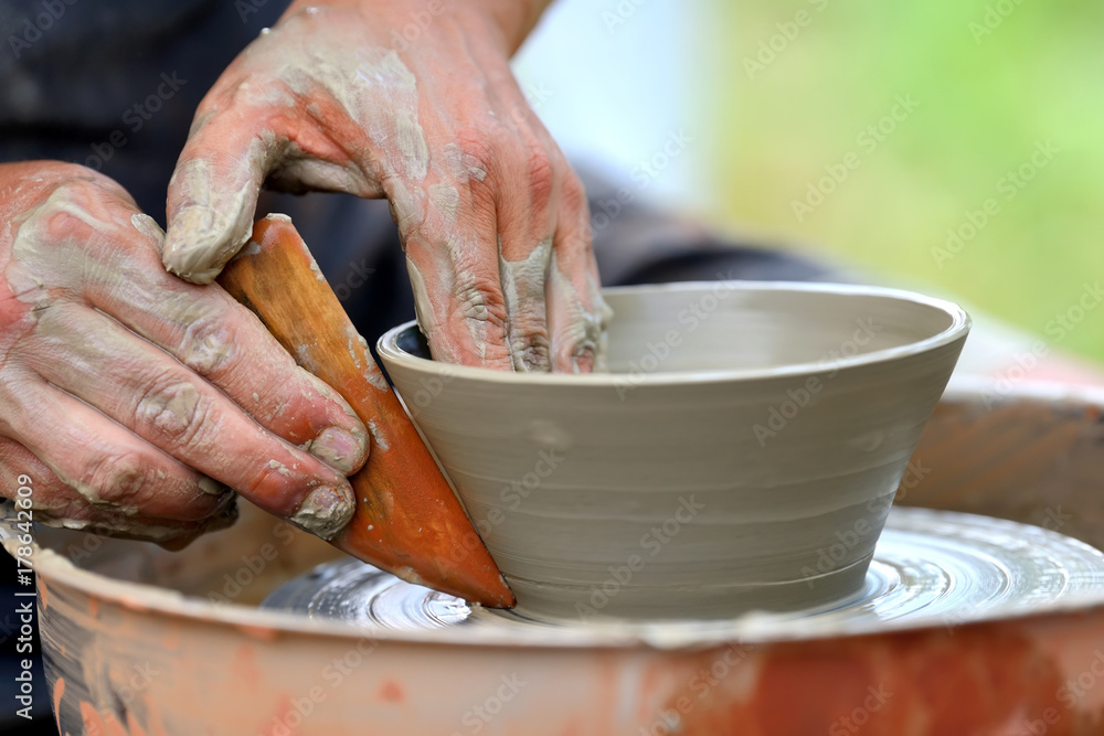 Potter making ceramic pot on the pottery wheel