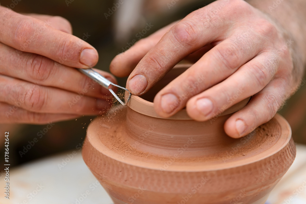 Potter making ceramic pot on the pottery wheel