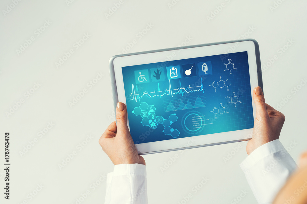 Close of female doctor hands working with tablet pc computer