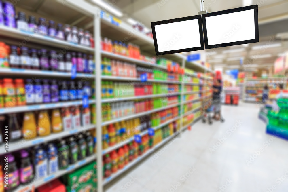 Blank supermarket TV screen and blurred supermarket drinks background