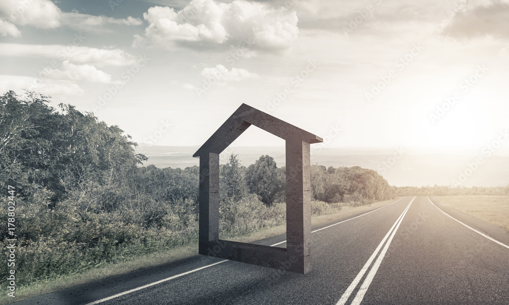 Conceptual background image of concrete home sign on asphalt roa