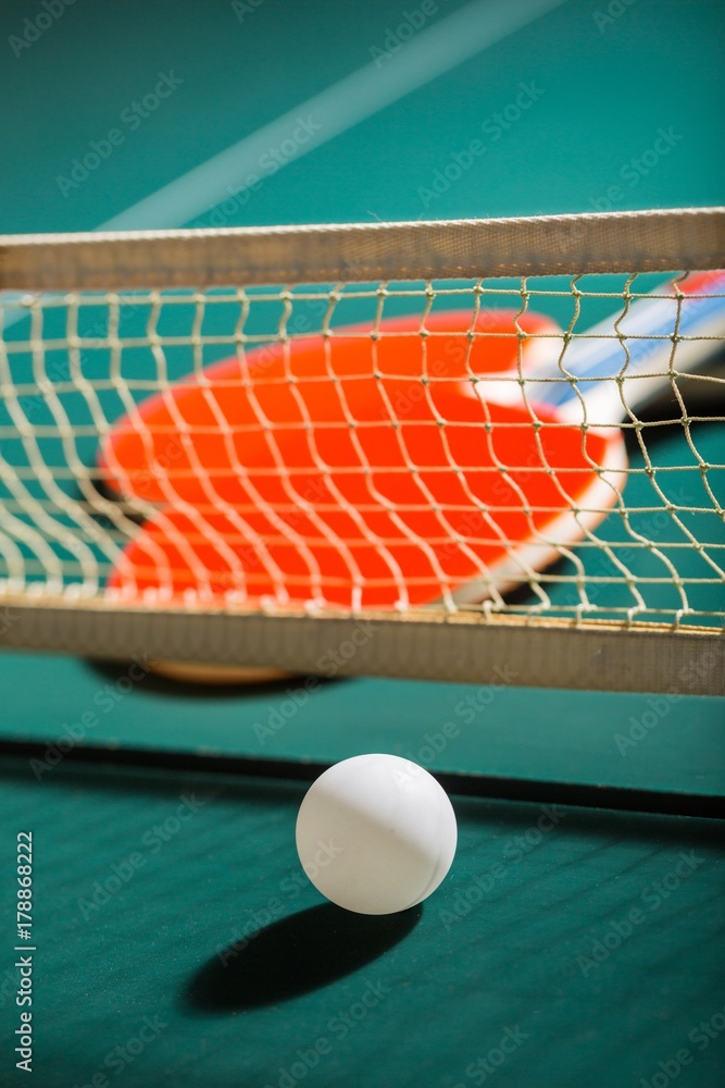 Table Tennis Rackets and Ball on Table with Net