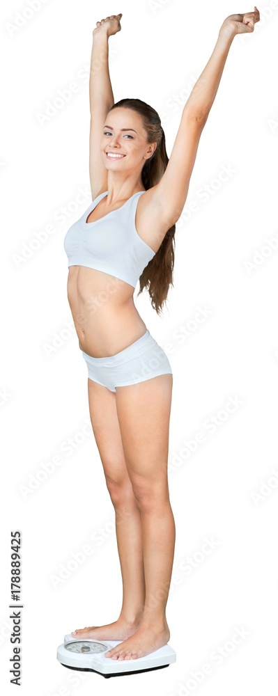 Portrait of a Fit Woman Celebrating on a Weight Scale