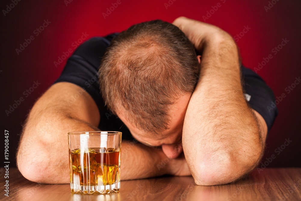 Drunk Man Sleeping At Bar Counter