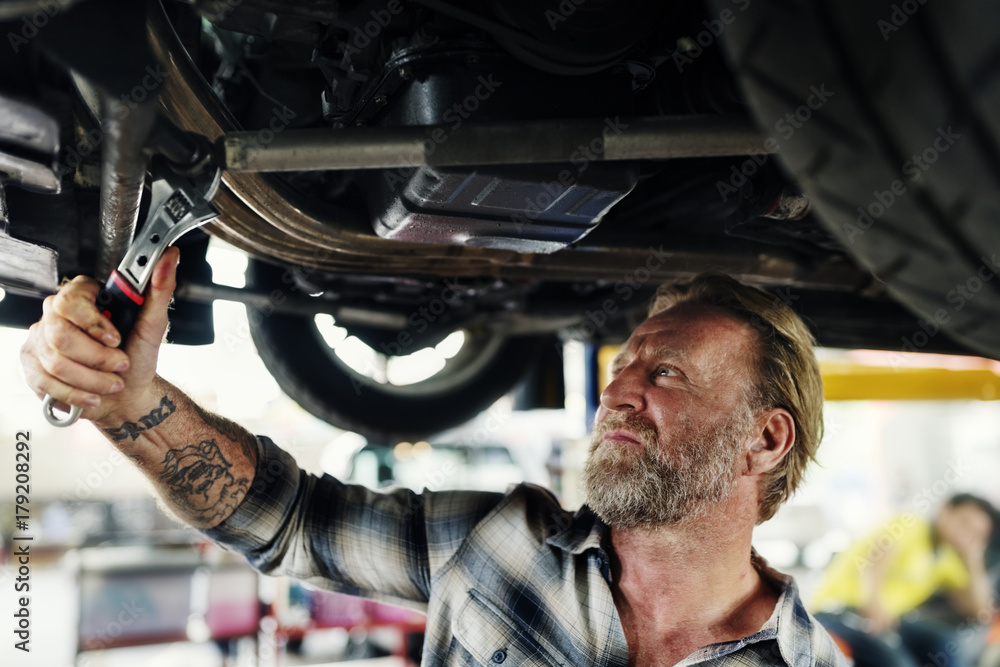 A mechanic fixing a car