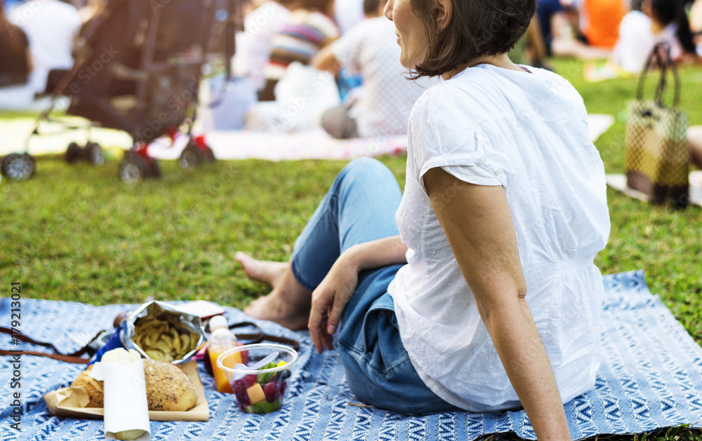 An Adult Woman Sitting and Picnicking in The Park