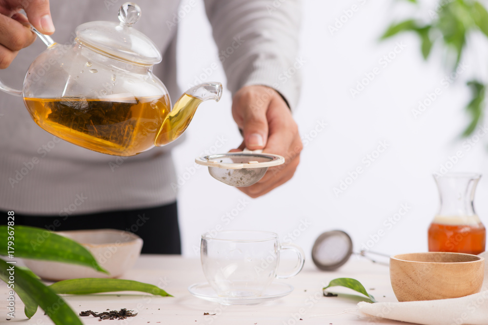 Poured from a teapot cup of tea on a wooden table