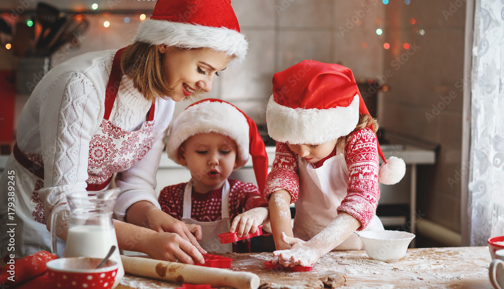 happy family mother and children  bake cookies for Christmas