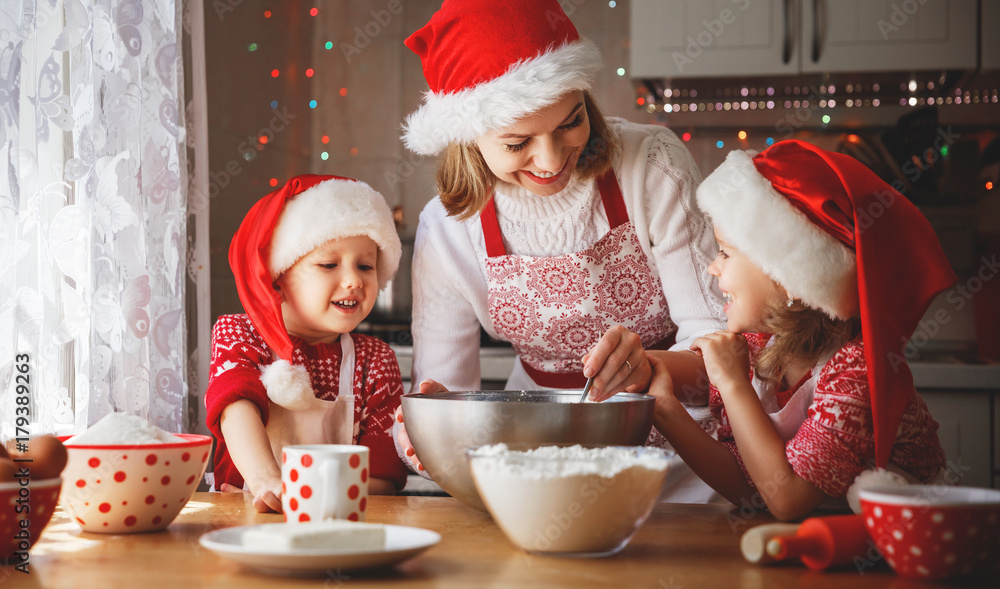 happy family mother and children  bake cookies for Christmas