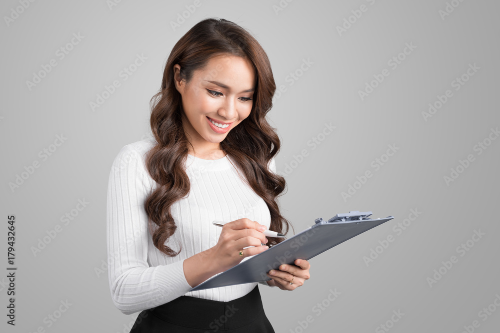 Portrait of young confident asian business woman with clipboard