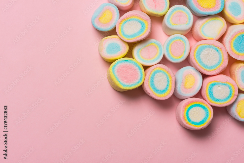 Minimal flat lay. Top view of the pastel marshmallows on a pinkbackground.