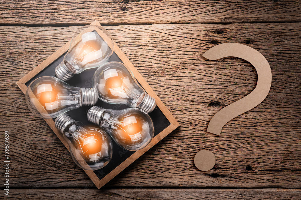 creativity ideas concept with light bulb on chalkboard on wooden texture background with free copysp