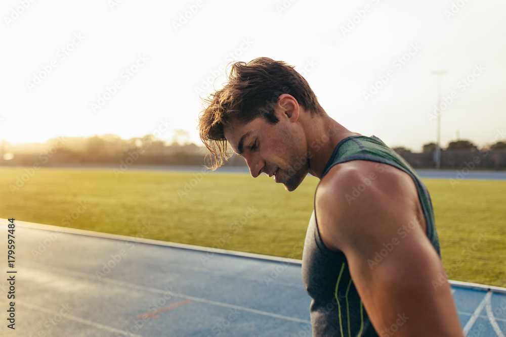 Sprinter standing on running track