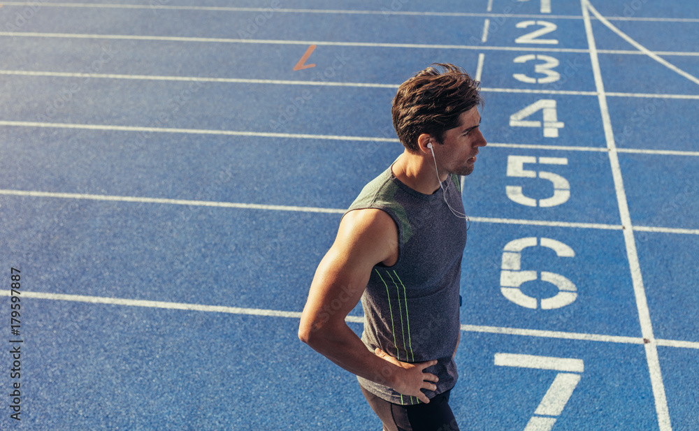 Sprinter standing on running track