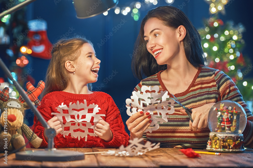 Mom and daughter near Christmas tree