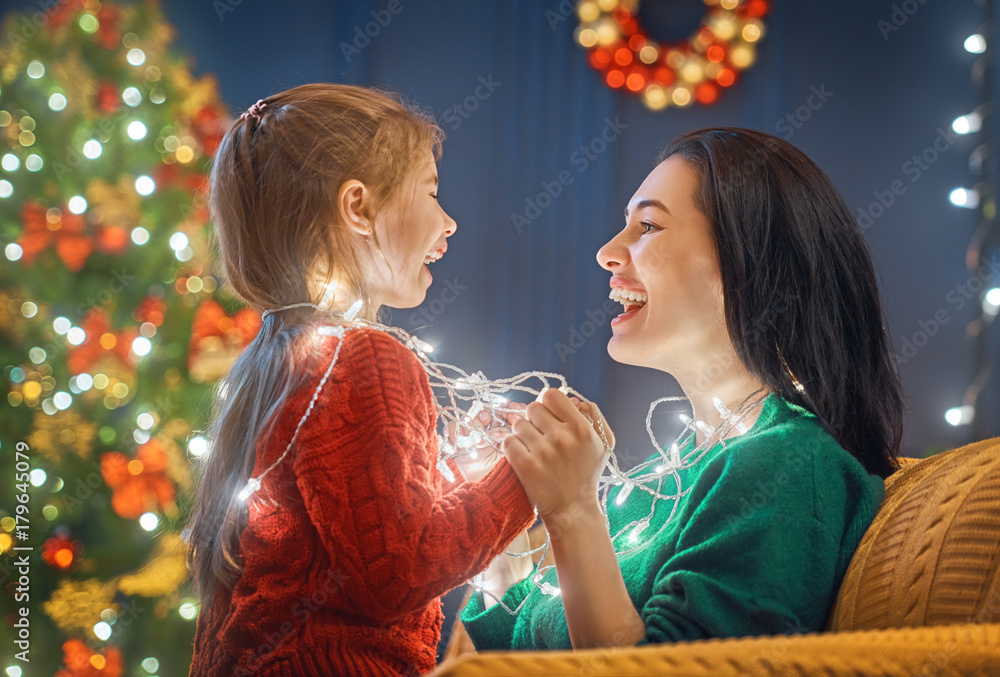 Mom and daughter near Christmas tree