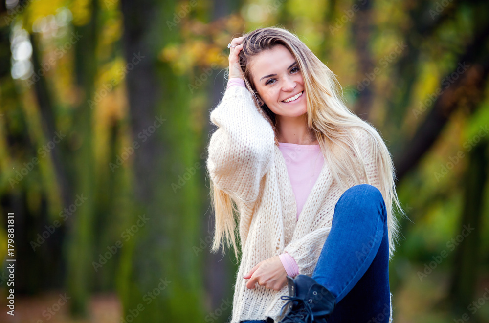 Girl in warm sweater on fall background