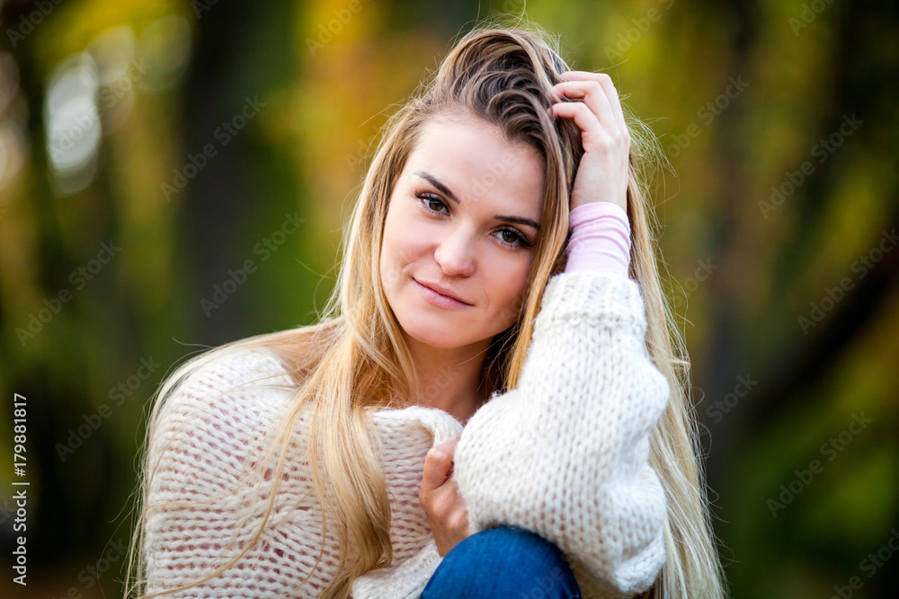 Girl in warm sweater on fall background