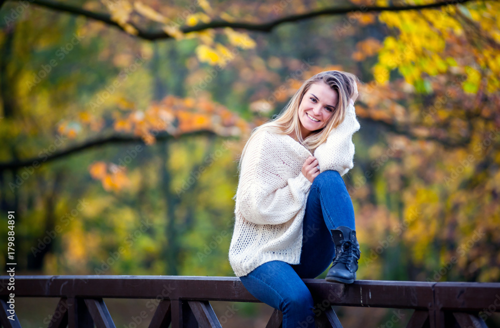 Beautiful young girl in the colorful autumn park