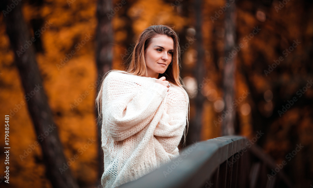 Beautiful woman in sweater enjoy colorful autumn