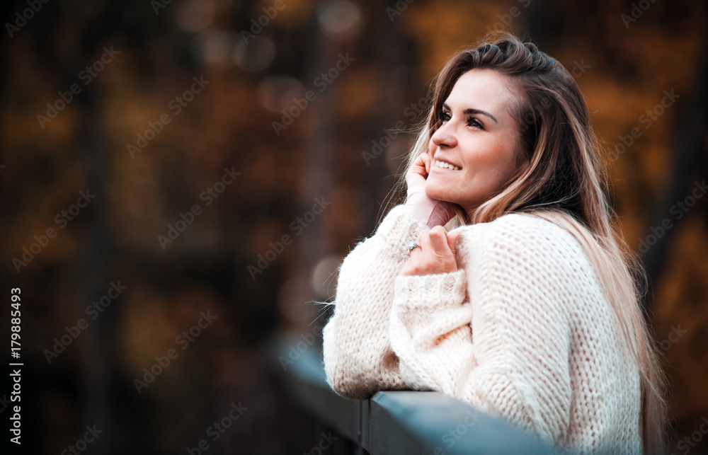 Beautiful woman in sweater enjoy colorful autumn