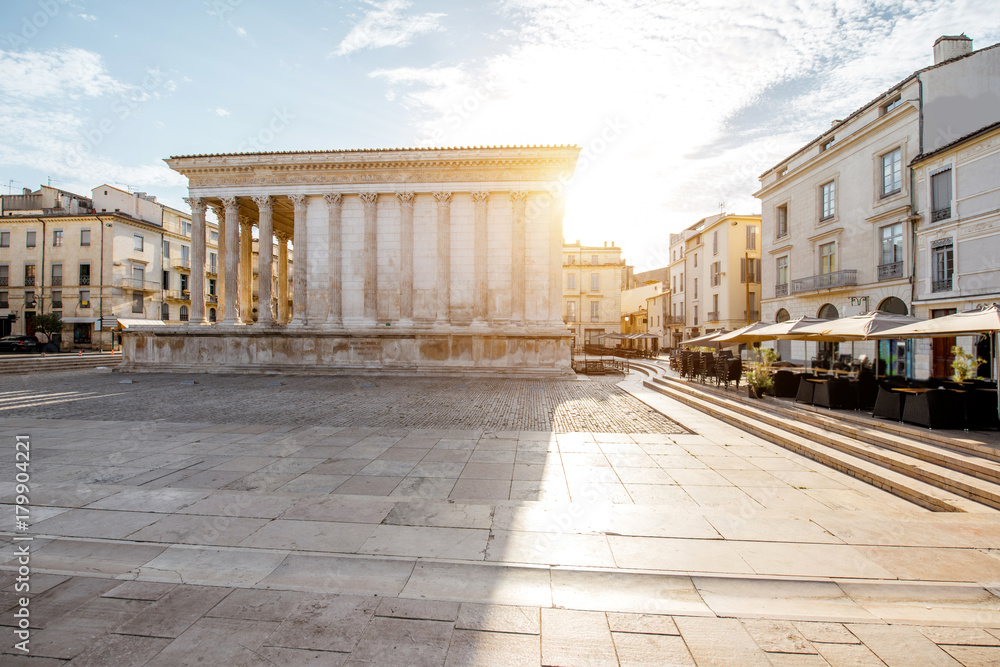 View on the ancient Roman temple Maison Carree during the sunny morning in Nimes in the Occitanie re