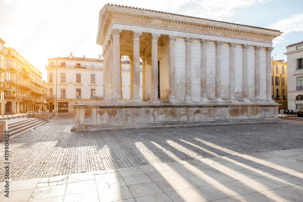 View on the ancient Roman temple Maison Carree during the sunny morning in Nimes in the Occitanie re