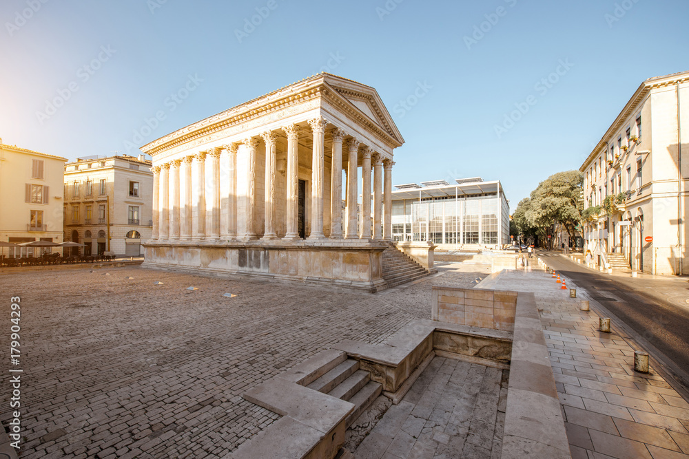 View on the ancient Roman temple Maison Carree during the sunny morning in Nimes in the Occitanie re