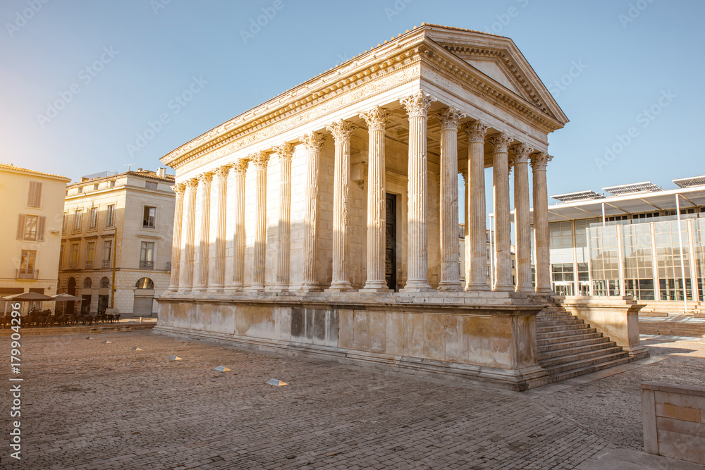 View on the ancient Roman temple Maison Carree during the sunny morning in Nimes in the Occitanie re