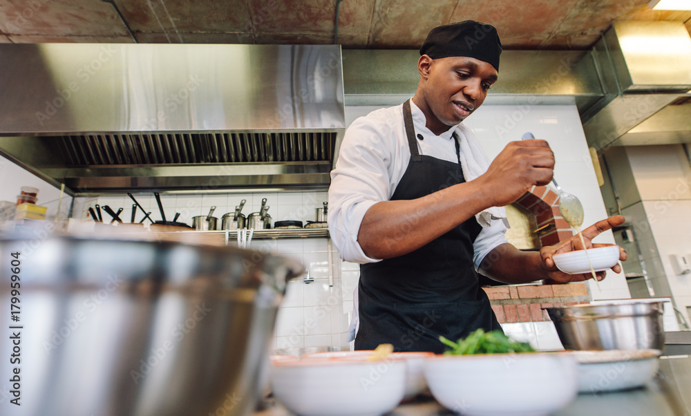 Chef cooking food in restaurant kitchen