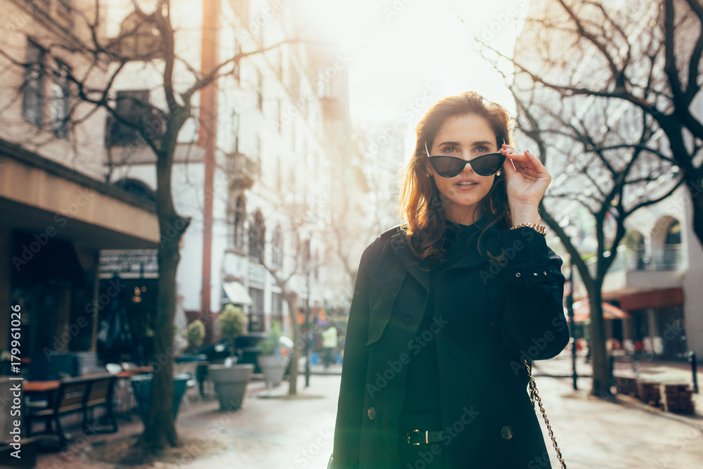 Attractive young woman walking down the street