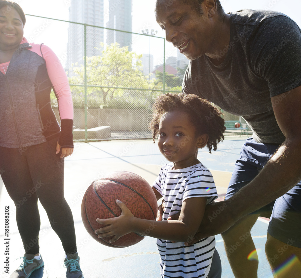 Father playing basketball with his child