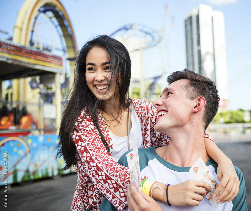 Young couple having fun together at an amusement park