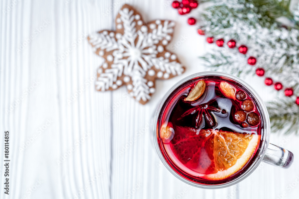 Christmas mulled wine with spices in cup on wooden background