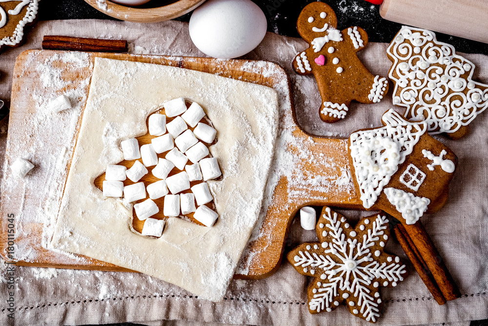 cooking christmas gingerbread on wooden background top view