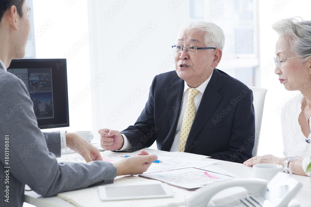 An old couple is talking to real estate salespeople