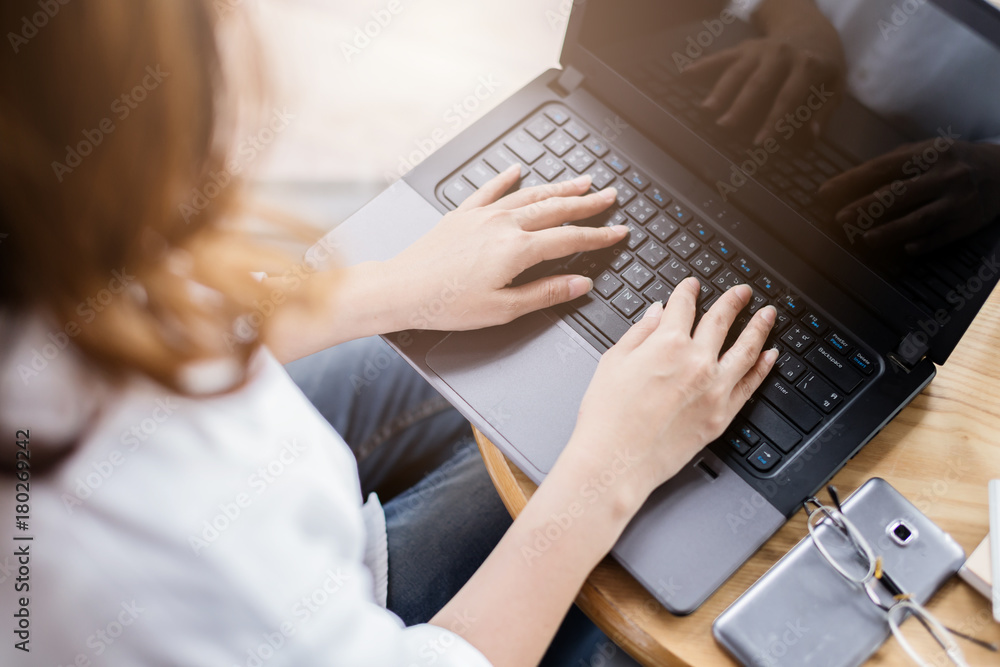 business concept with business woman working with business graph and laptop and smartphone on wooode