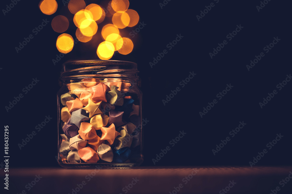 Star origami in glass jar with a festival light , symbol for gift celebration in happy time for new 