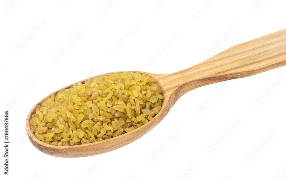 Dry bulgur wheat in wooden spoon isolated on white background