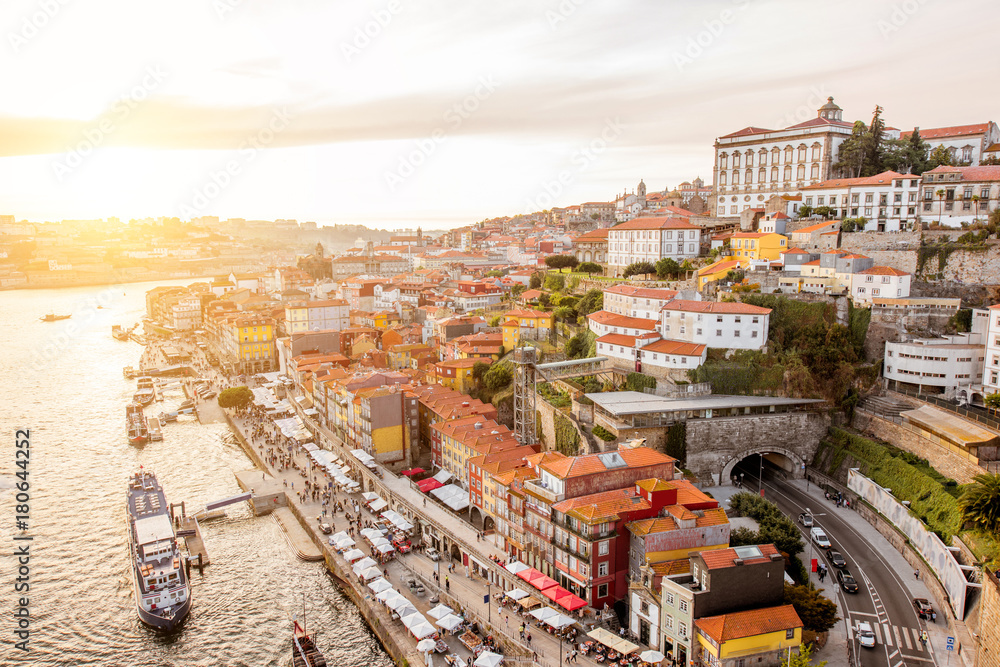 Top view on the Douro river with Ribeira promenade in the old town of Porto city during the sunset i