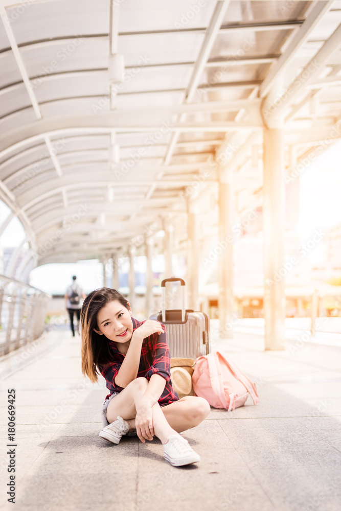 beautiful happiness young asian girl in casual dress traveling alone at train station or airport wit